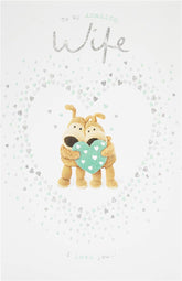UK Greetings romantic anniversary card for wife featuring a heartfelt design with a holding heart illustration.