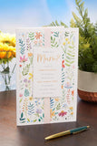 UK Greetings Mother's Day Card for Mum featuring the "What Is a Mum?" design, with colorful floral illustrations and heartfelt message.