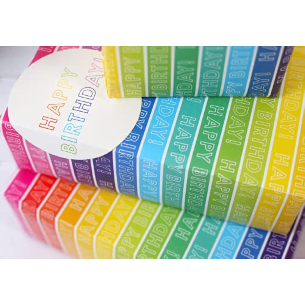 Colorful rainbow stripe gift wrap sheets and matching greeting card tags by Abacus Cards, featuring vibrant, cheerful designs.