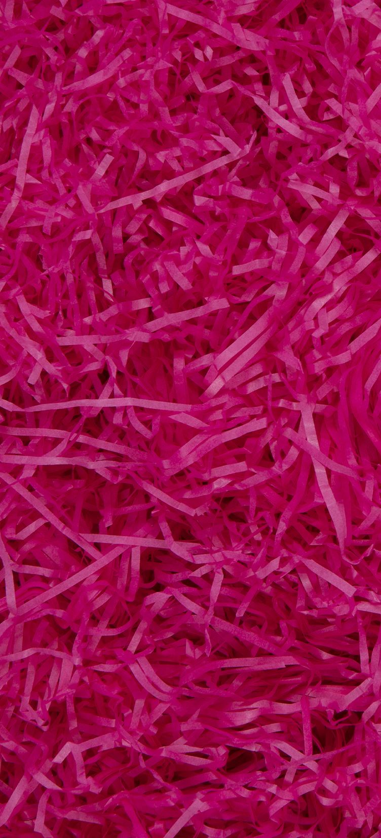 Glick Cerise shredded tissue paper for gift packaging, used as void fill and decorative accessory in gift boxes.
