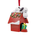 Hallmark Peanuts Snoopy on doghouse Christmas ornament, festive holiday decoration featuring Snoopy from the Peanuts comic strip.