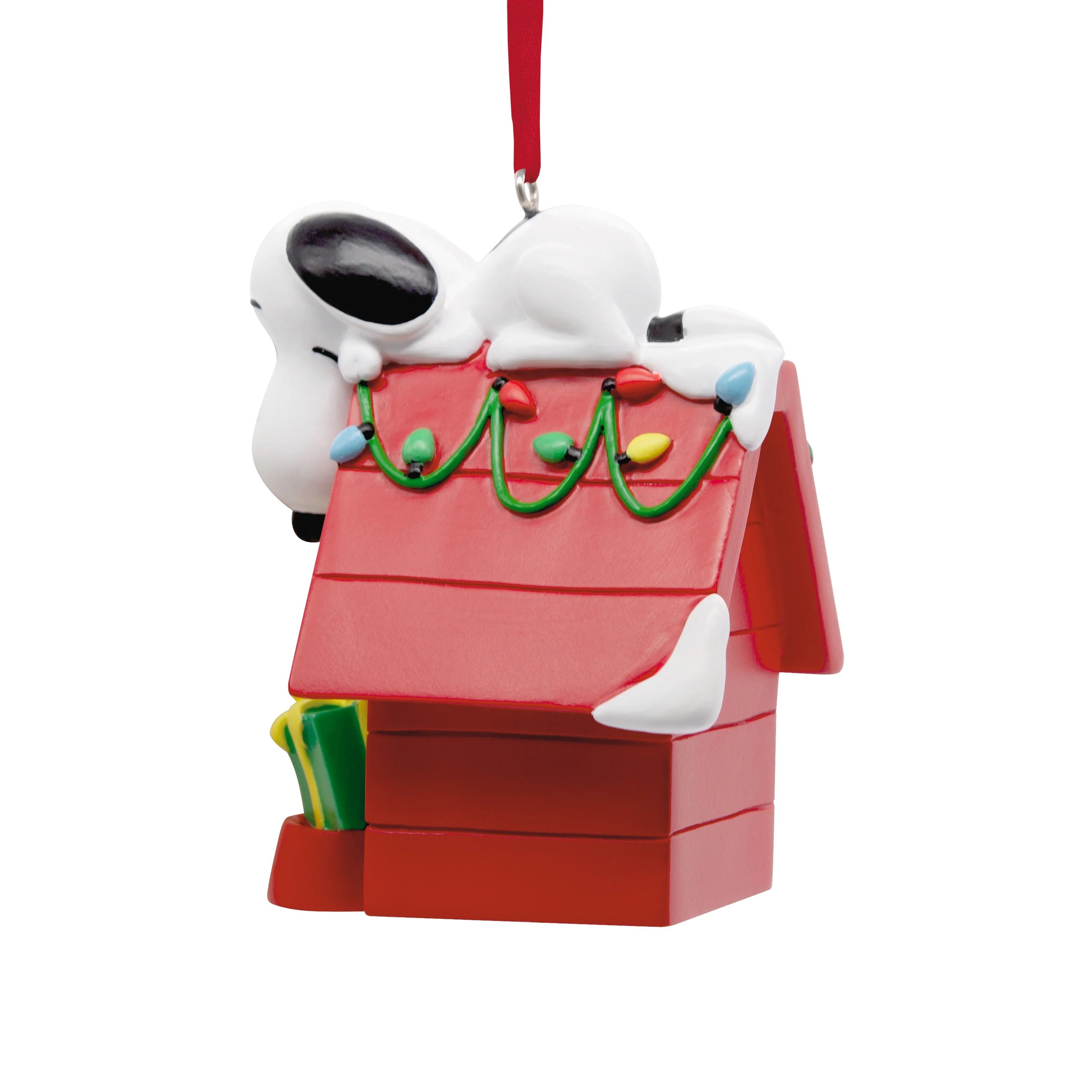Hallmark Peanuts Snoopy on doghouse Christmas ornament, festive holiday decoration featuring Snoopy sitting on his red doghouse.