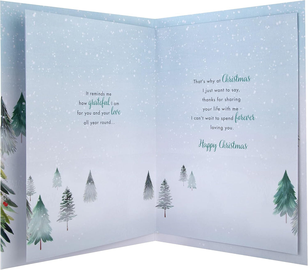 Hallmark boxed Christmas card for fiancé featuring a classic winter scene with a decorated tree design.