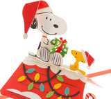 Hallmark 3D pop-up Christmas card featuring Snoopy and Woodstock from Peanuts with festive holiday design.