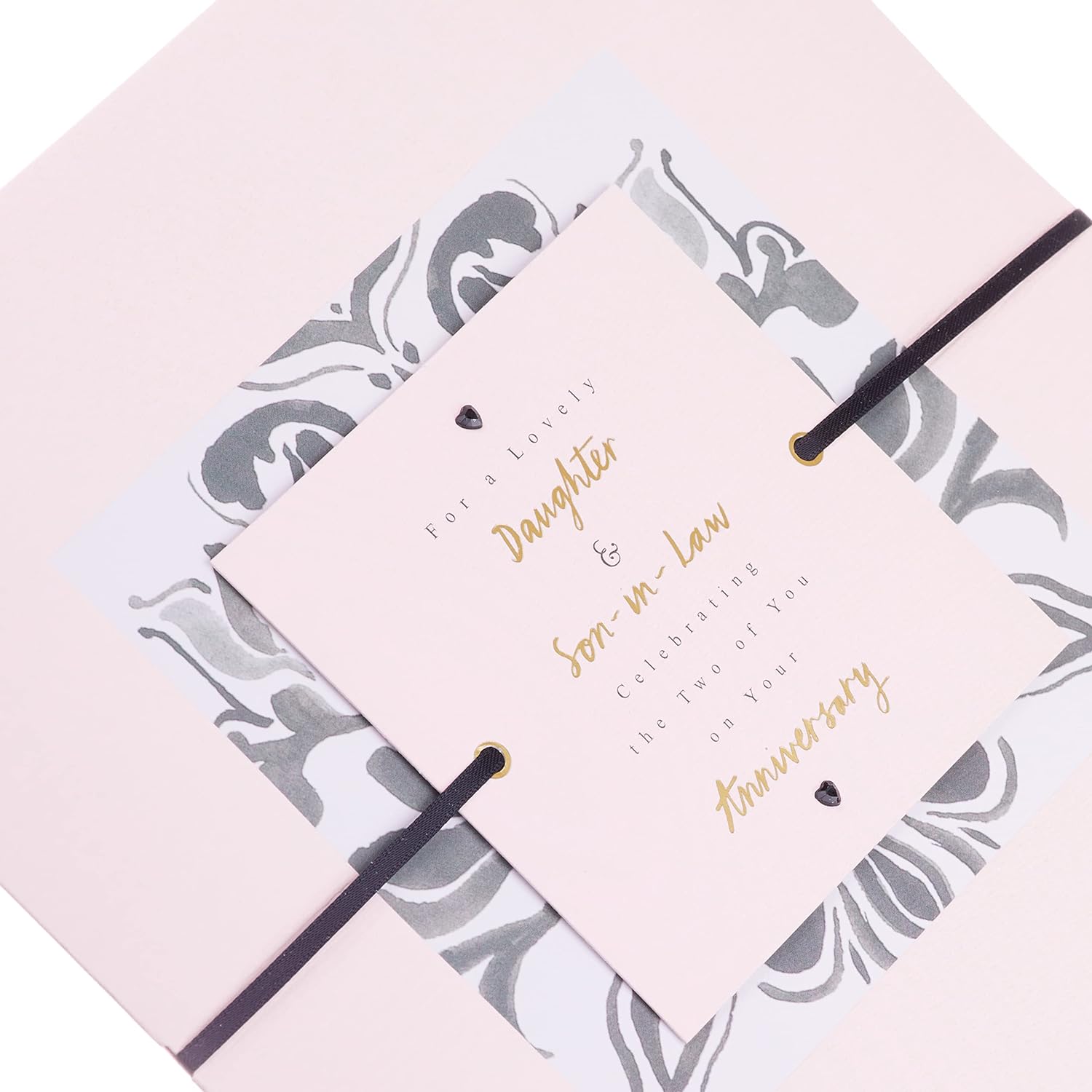 Hallmark anniversary greeting card for daughter and son-in-law with contemporary text-based design, featuring elegant floral accents.