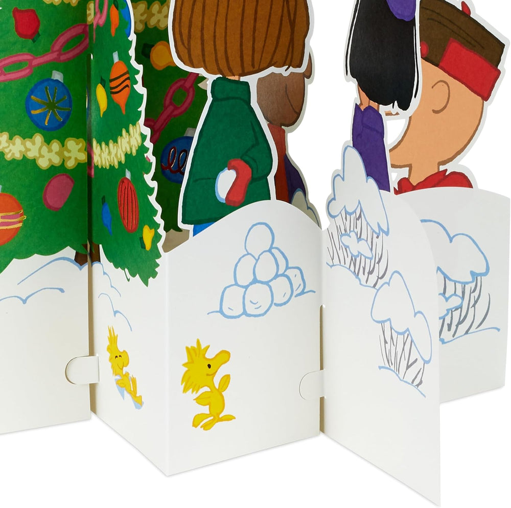 Hallmark 3D pop-up Christmas card featuring Peanuts characters Charlie Brown and Snoopy with a decorated Christmas tree.