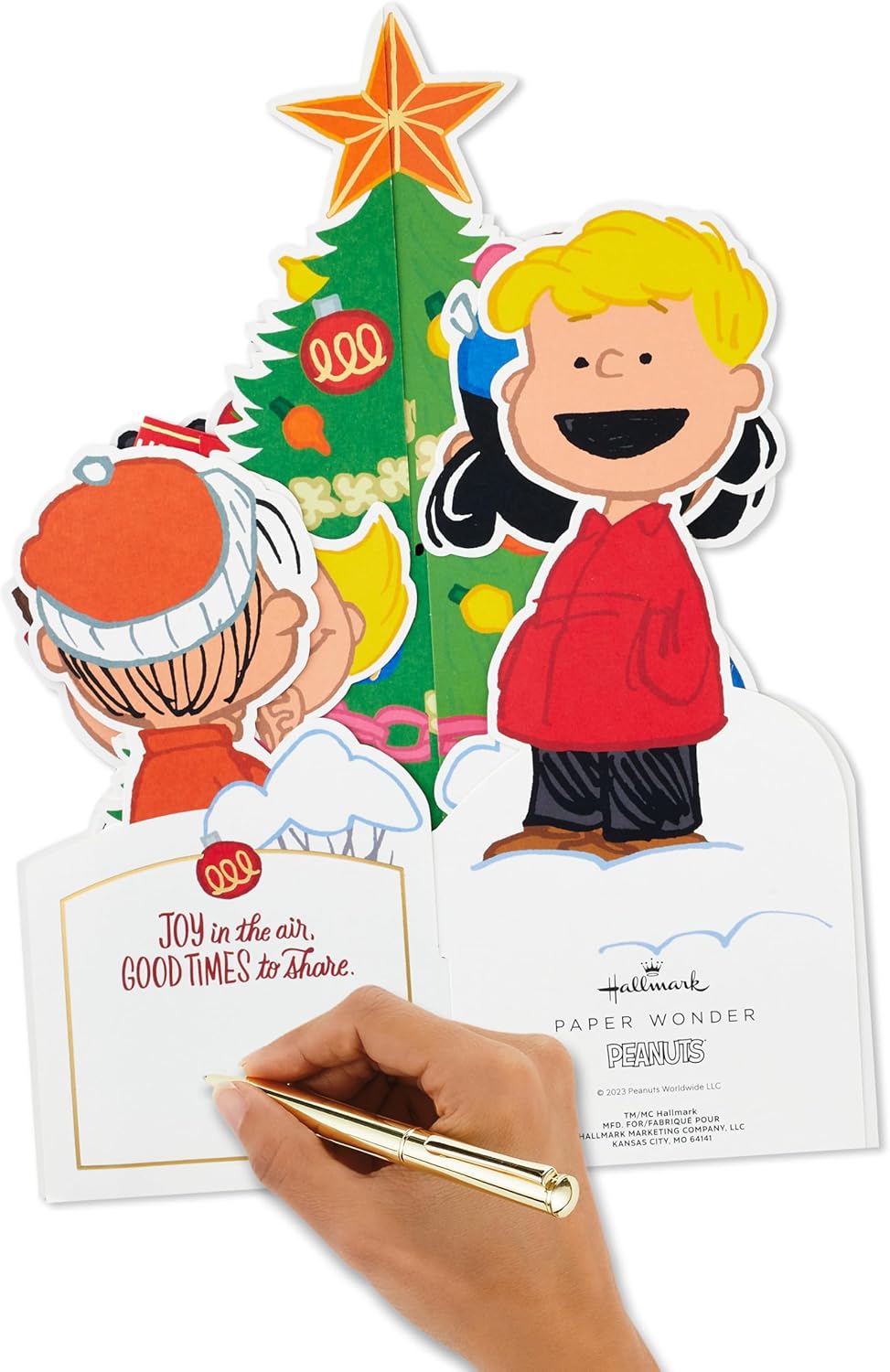 Hallmark Christmas card featuring 3D pop-up design with Peanuts characters Charlie Brown and Snoopy with a Christmas tree.