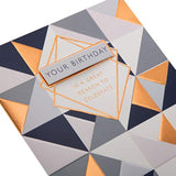 Hallmark birthday greeting card with geometric foil design and 3D tag, featuring vibrant colors and modern decorative elements.