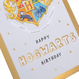 Hallmark Harry Potter Hogwarts House Crest birthday greeting card featuring Gryffindor, Slytherin, Hufflepuff, and Ravenclaw emblems.