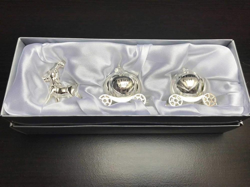Silver keepsake box by Joe Davies featuring a Cinderella carriage design for storing first tooth and curl keepsakes.