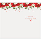 Festive Figure Holding Christmas Greeting Card with Seasonal Design and Warm Wishes