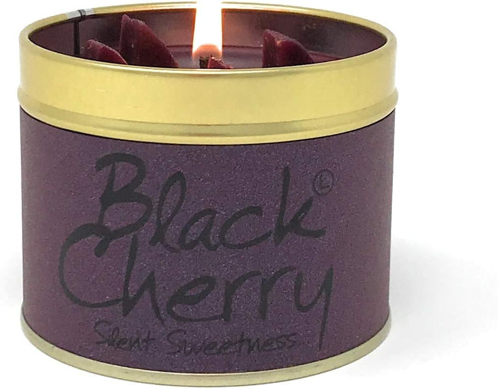 Lily-Flame Black Cherry scented tin candle with black and red cherry design and a lit wick, inside a decorative metal tin.
