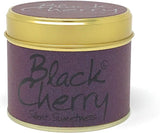 Lily-Flame Black Cherry scented tin candle with black cherry illustration, compact metal container, and floral design on the label.