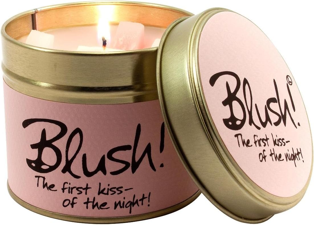 Lily-Flame Blush scented tin candle with pink floral design and a lit wick, showcasing a cozy, fragrant candle in a metal tin.