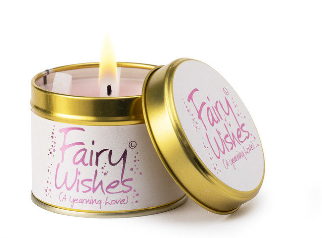 Lily-Flame Fairy Wishes scented tin candle with decorative label and a lit wick, designed for cozy ambiance.