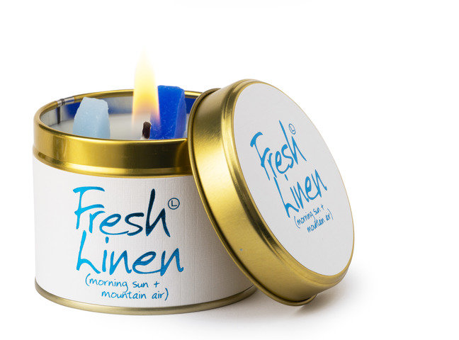 Lily-Flame Fresh Linen scented tin candle with a decorative label, perfect for home fragrance and ambient lighting.