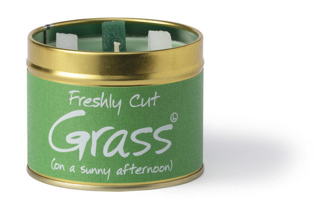 Lily-Flame Freshly Cut Grass scented tin candle with green label and metal lid, showcasing the candle's fresh grass scent.