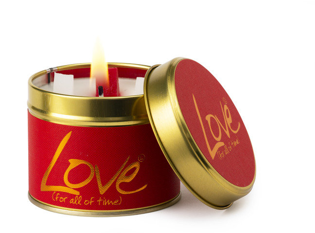 Lily-Flame Love scented tin candle with floral design, compact metal container, and soft pink label, perfect for cozy ambiance.