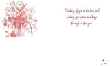 Thinking of You at Christmas greeting card by NQ featuring a poinsettia flower in a vase design.