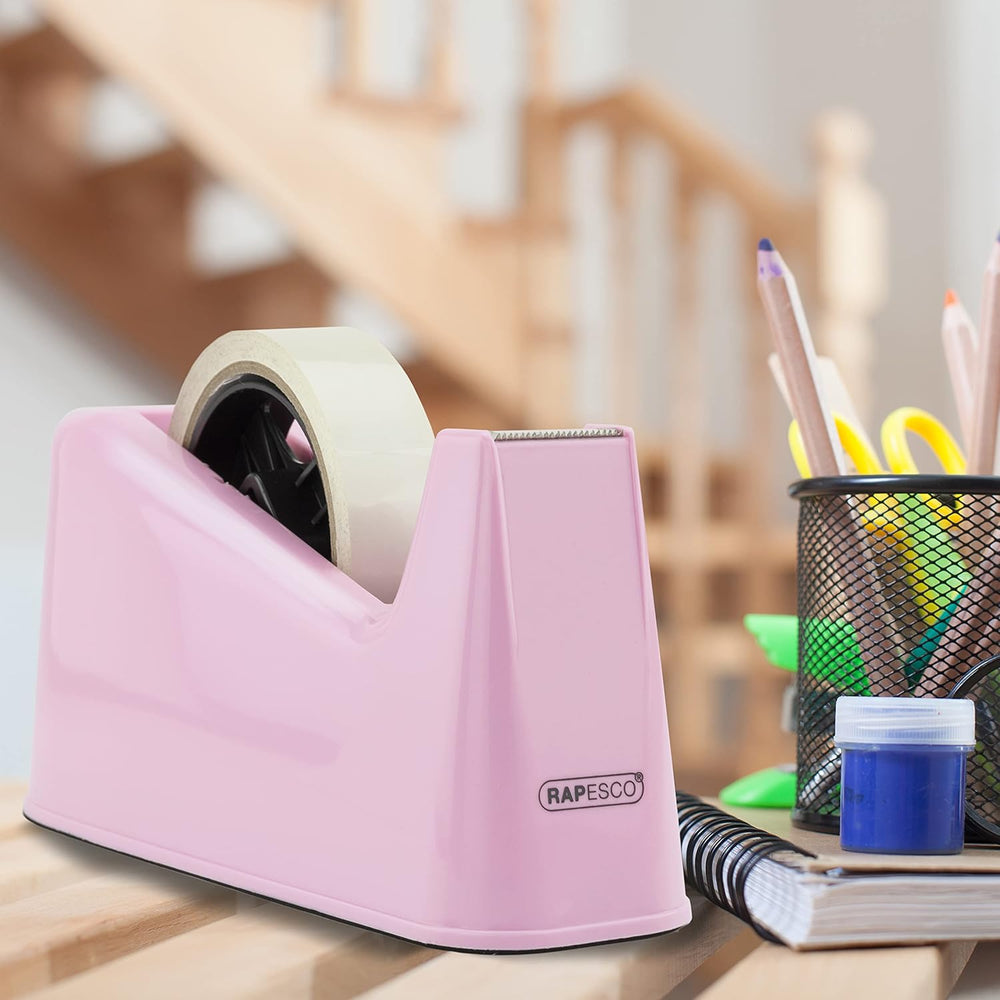 Rapesco heavy duty tape dispenser with two candy pink tape rolls, durable plastic design for office or home use.