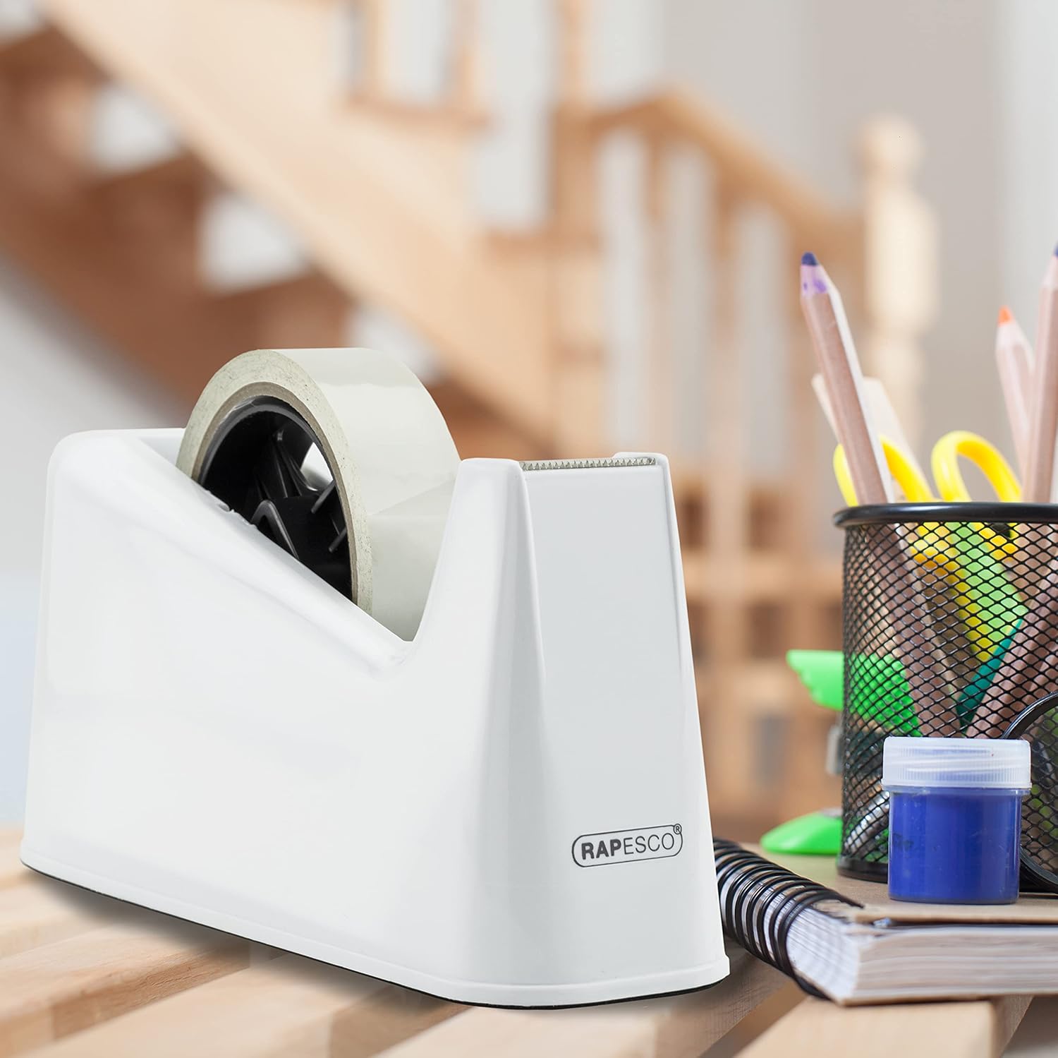 Rapesco 500 heavy-duty tape dispenser with two white tape rolls, sturdy plastic construction, and ergonomic handle.