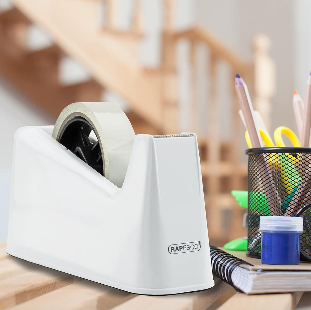 Rapesco 500 heavy-duty tape dispenser with two white tape rolls, sturdy plastic construction, and ergonomic handle.