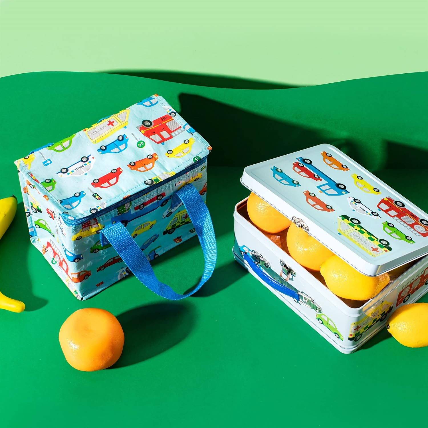 Sass & Belle Transport lunch bag for kids with colorful train design, insulated fabric, and carry handle.