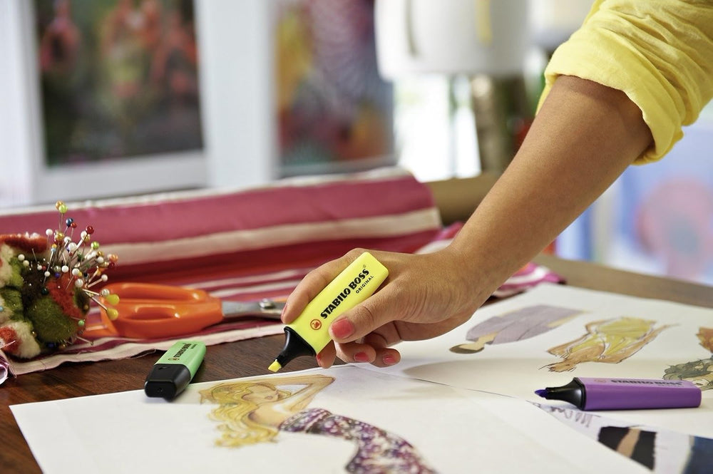 Set of four Stabilo Boss Original yellow highlighters with chisel tips, designed for vibrant highlighting and easy visibility.