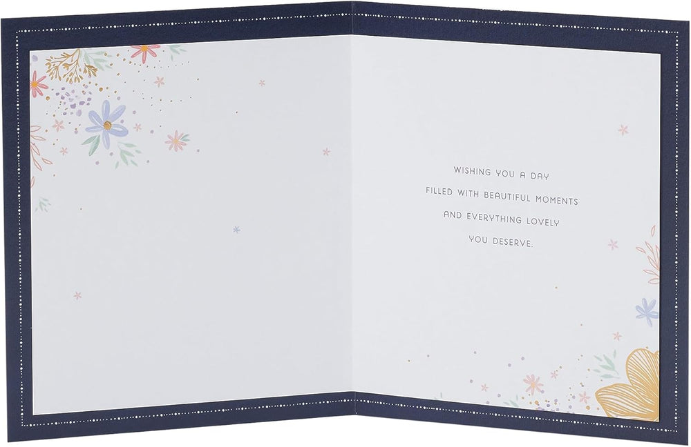 UK Greetings birthday card for sister featuring floral perfume design with colorful floral artwork and elegant lettering.