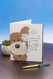 UK Greetings Lots of Woof birthday card featuring a cute, playful dog design for celebrating birthdays.