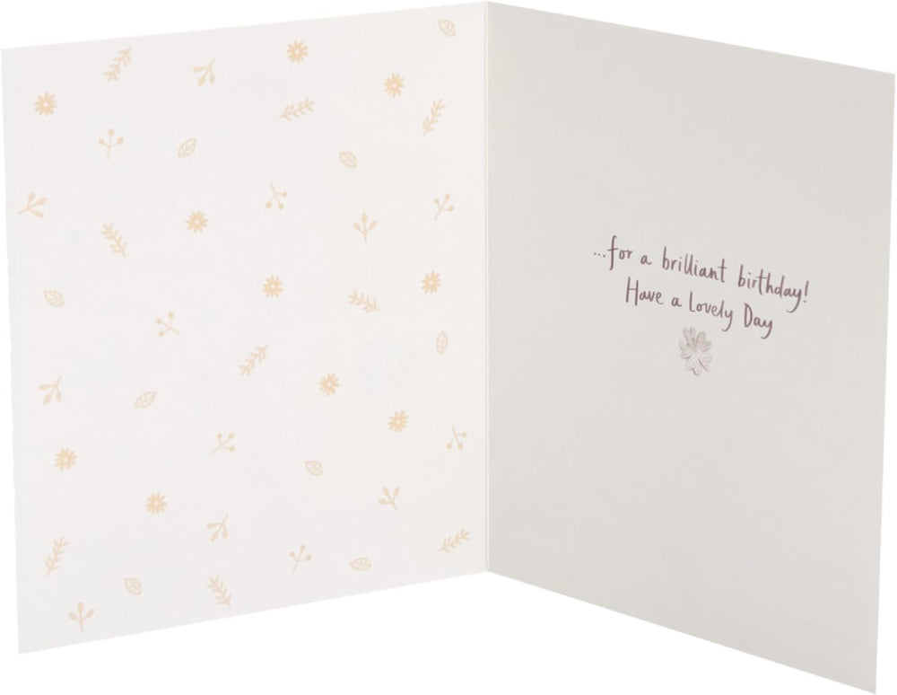 UK Greetings Lots of Woof birthday card featuring a cute, playful dog with colorful birthday-themed illustrations.