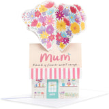 UK Greetings birthday card for mum featuring a pop-up flower shop design, with colorful floral illustrations.