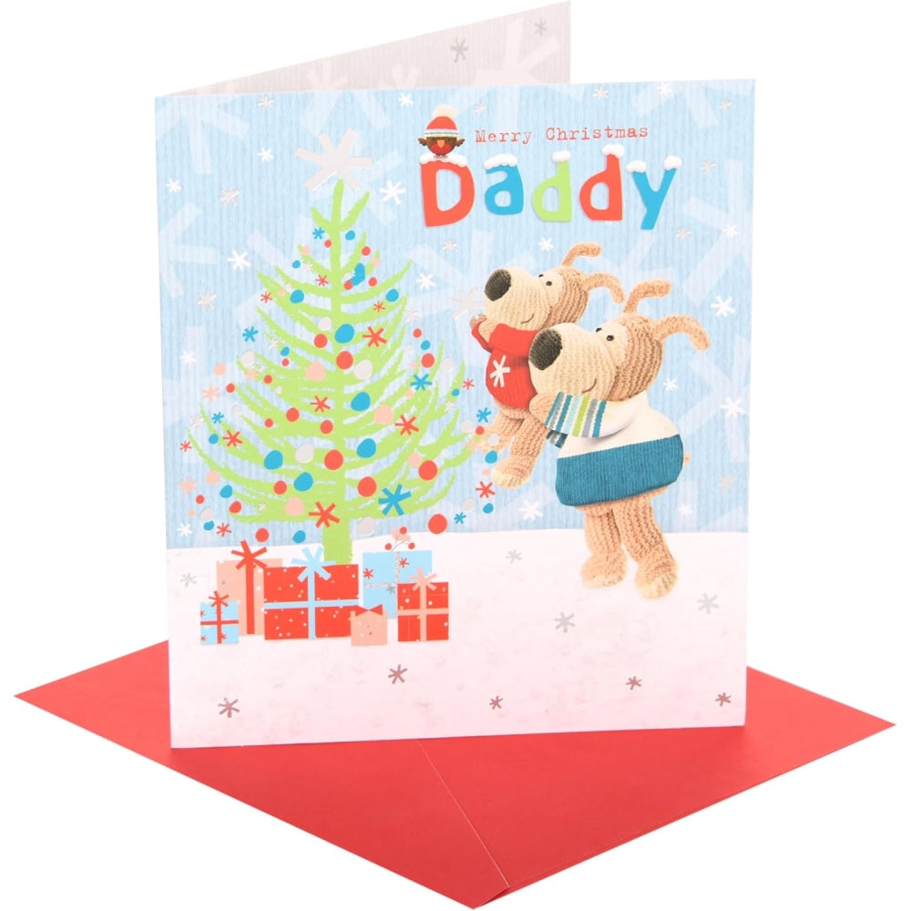 UK Greetings Boofle Christmas card featuring a festive scene near a Christmas tree, designed for celebrating Christmas with loved ones.