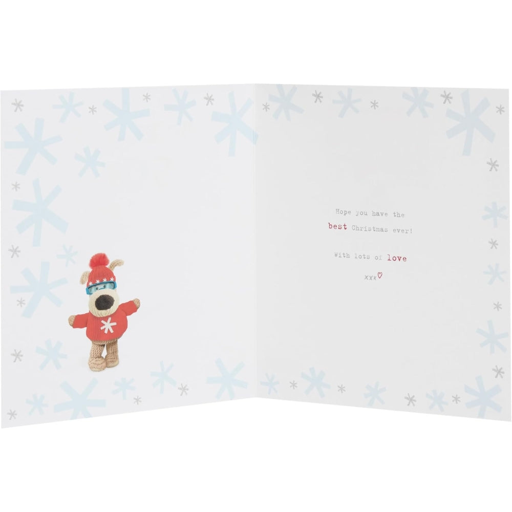 UK Greetings Boofle skiing son Christmas card with festive illustration of Boofle in winter attire and holiday scenery.