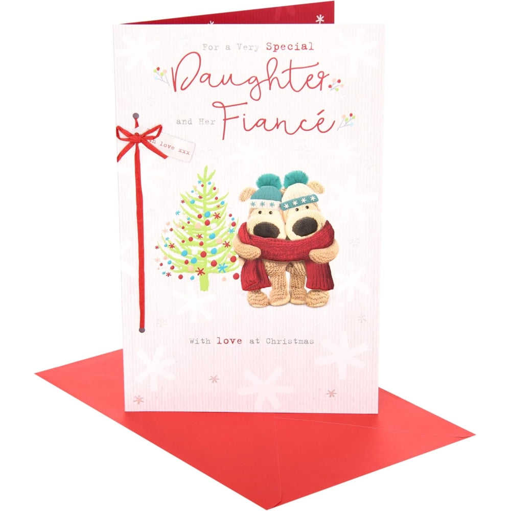UK Greetings Boofles Christmas card featuring a daughter and fiancé near a decorated Christmas tree.