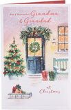 UK Greetings Christmas greeting card for grandma and grandad featuring a snowy door design with festive holiday imagery.