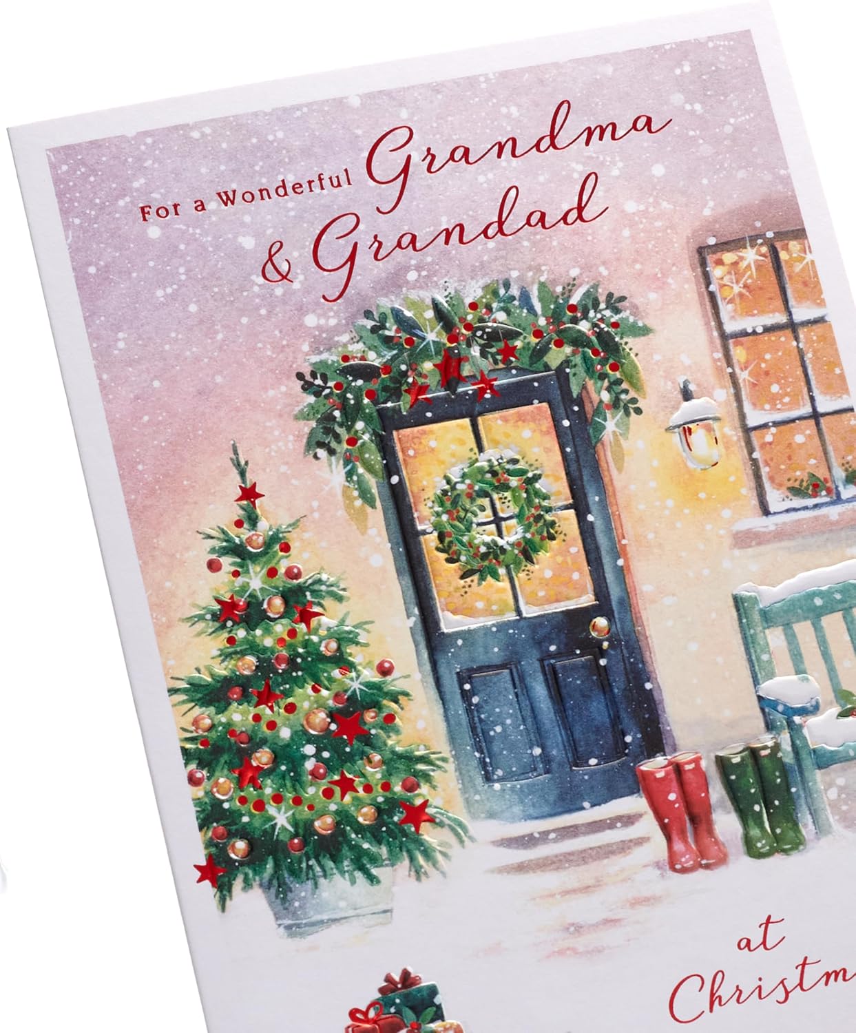 UK Greetings Christmas greeting card for Grandma and Grandad featuring a snowy door design, perfect for holiday wishes.