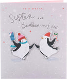 UK Greetings Christmas greeting card featuring cute penguins ice skating, designed for sisters and brothers-in-law.