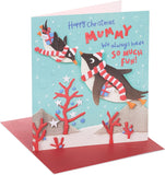 UK Greetings Christmas greeting card for Mummy featuring cute penguins and festive holiday design, with colorful seasonal illustrations.