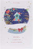 UK Greetings Christmas greeting card featuring a snow globe with robins and a granddaughter, with multi-caption festive design.