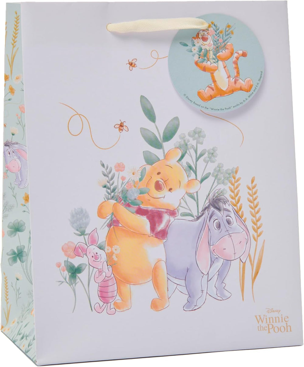 Medium Disney Winnie the Pooh gift bag by UK Greetings featuring colorful Pooh and friends on a playful background.