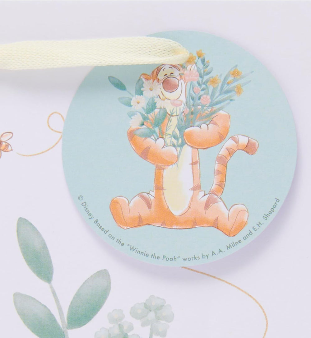 Medium Disney Winnie the Pooh gift bag by UK Greetings with colorful Pooh and friends design for special occasions.