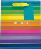 UK Greetings rainbow design medium gift bag with colorful handles and cheerful rainbow pattern for gift packaging.