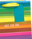 UK Greetings Rainbow Design medium gift bag with colorful rainbow pattern and sturdy handles for special occasions.