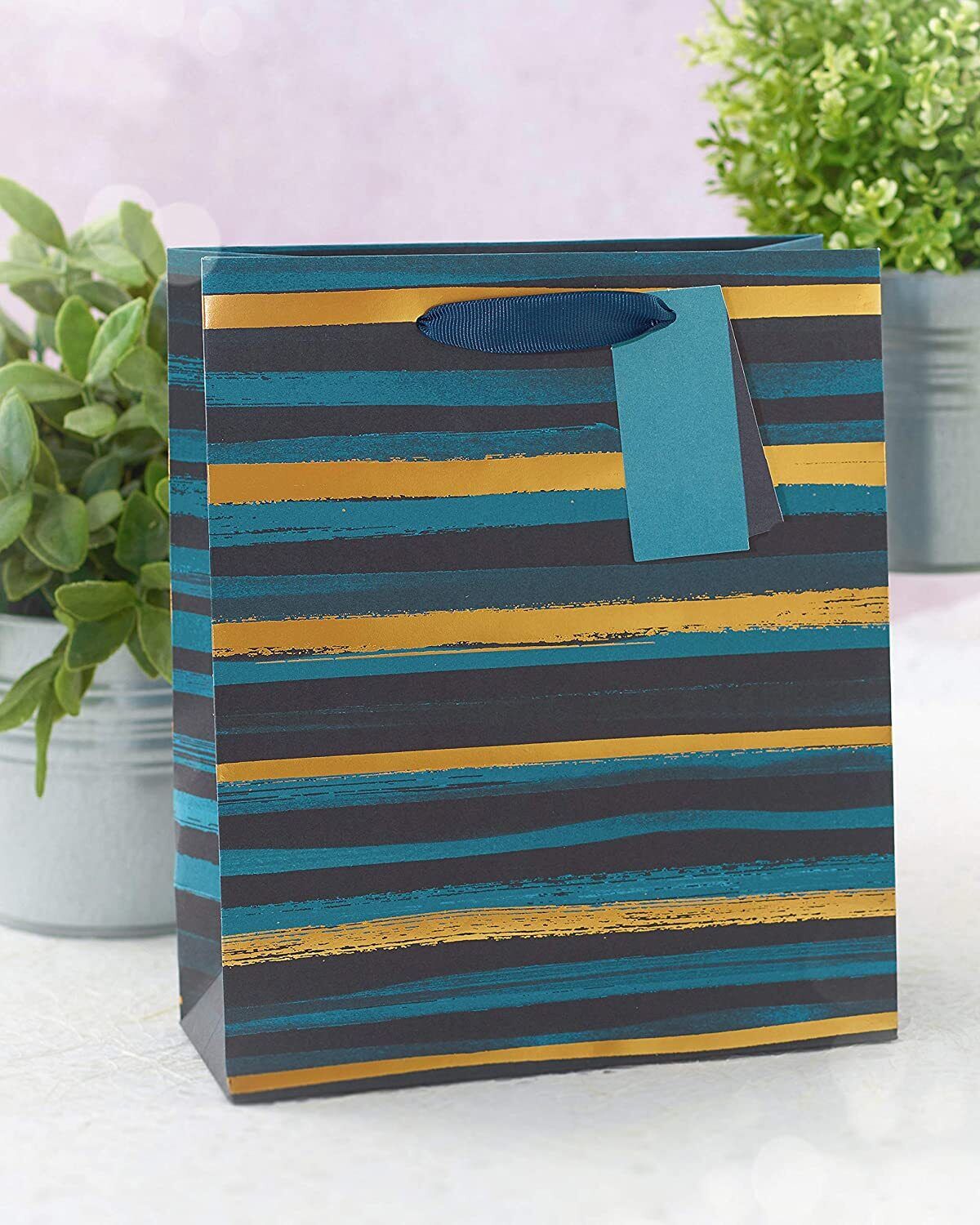 UK Greetings blue and gold stripe medium gift bag with handles, ideal for gift packaging and special occasions.