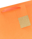 Bright orange UK Greetings large gift bag with handles, perfect for gift giving, featuring a vibrant and spacious design.