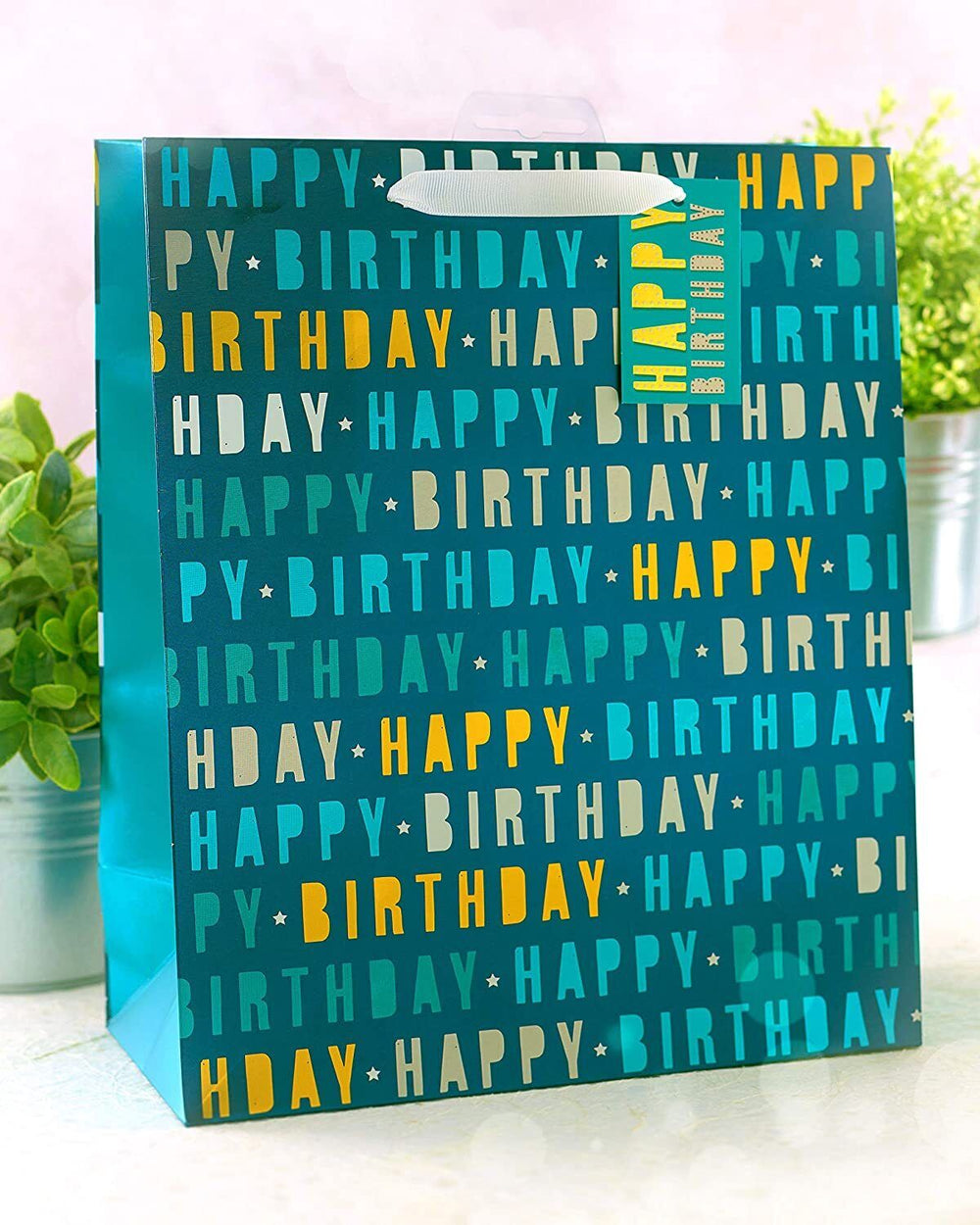 Large blue UK Greetings Happy Birthday gift bag with decorative design, perfect for celebrating special occasions.