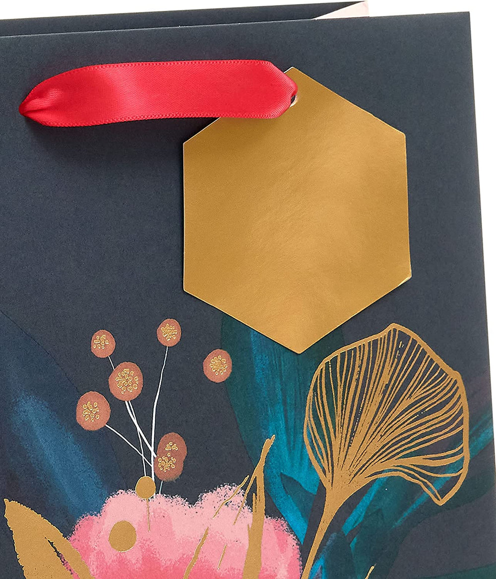 UK Greetings medium floral gift bag for her, featuring a feminine floral design, ideal for gift packaging.