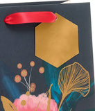 UK Greetings medium floral gift bag for her, featuring a feminine floral design, ideal for gift packaging.