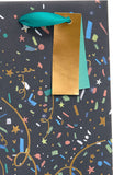 UK Greetings Party Popper design bottle gift bag for presents, featuring colorful party-themed graphics and sturdy handles.